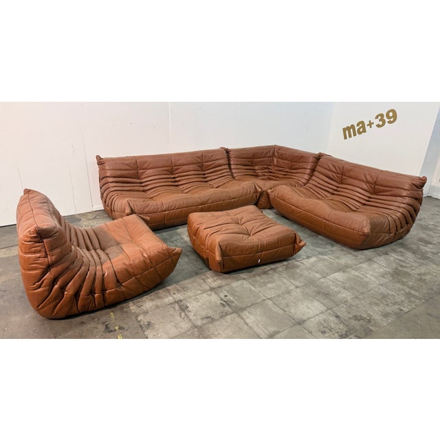 This stunning five-piece Togo sofa set in cognac brown leather brings an iconic blend of form, function, and timeless...
