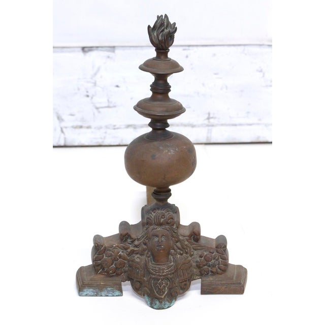 Highly ornate French style bronze pair of chenets with figural detail and a flame finial at the top. Good condition with...