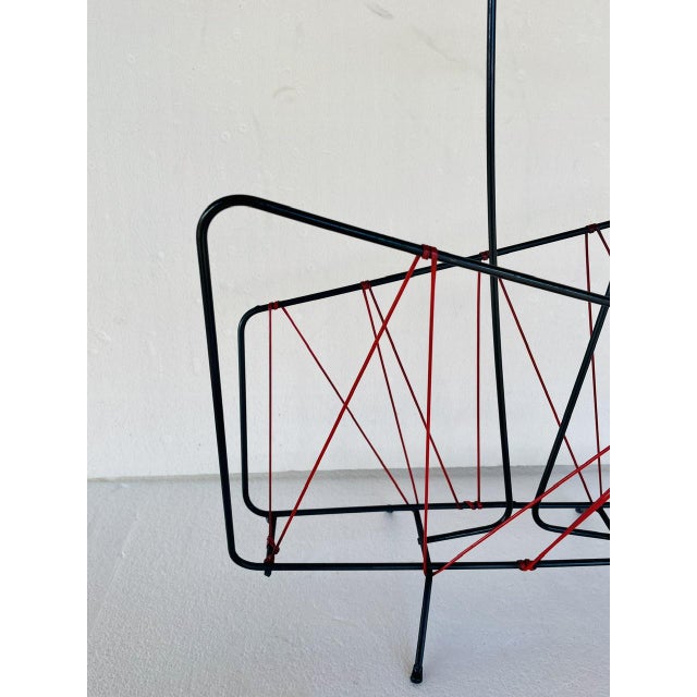 Vintage, mid-century, space age magazine rack made of metal and scoubidou, from the 1950's. the rack features a very cool,...