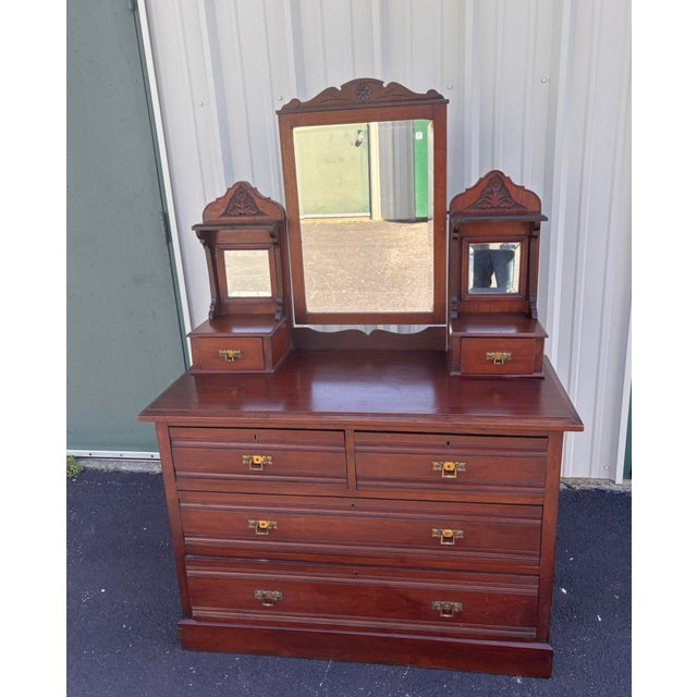 This exquisite chest of drawers or vanity is a beautiful find with solid mahogany construction in a Victorian Eastlake...