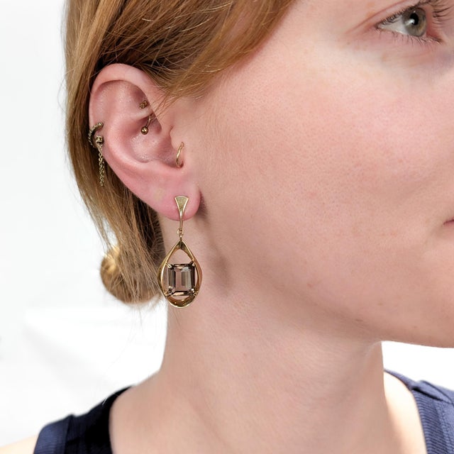 A fine pair of signed Modernist gold & topaz earrings. By Ronald Pearson. In 14 karat yellow gold. Each earring with a...