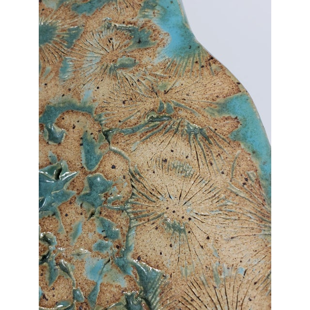 This gorgeous handmade pottery plate is a fantastic addition for home decor. This textured piece features florals and...