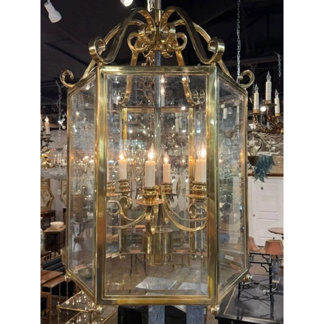 The Vintage English Large Scale Gilt Brass Lantern is a luxurious and elegant lighting fixture perfect for adding a touch...