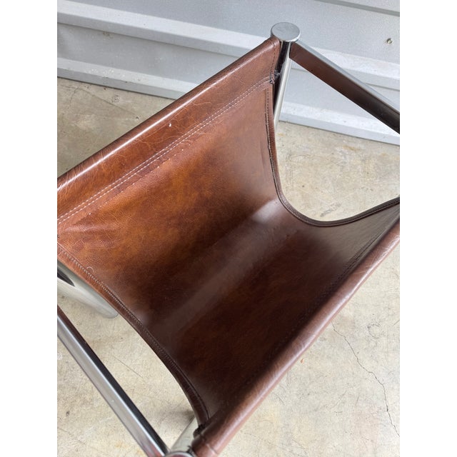 Nice retro style chrome and leather magazine holder. Some light wear on chrome legs due to age and use. Leather sling in...