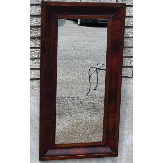 Beautiful mid-19th century American Empire ogee wall mirror, circa 1840–1860. Crafted with a figured mahogany veneer frame...