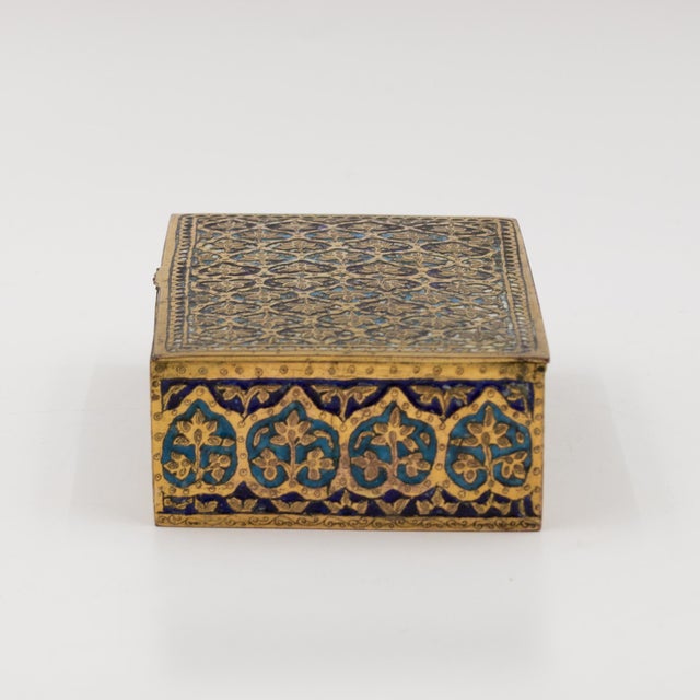 Likely Indo-Persian or Middle Eastern, circa 1900 Rectangular gilt brass box with champlevé enamel decoration overall in...