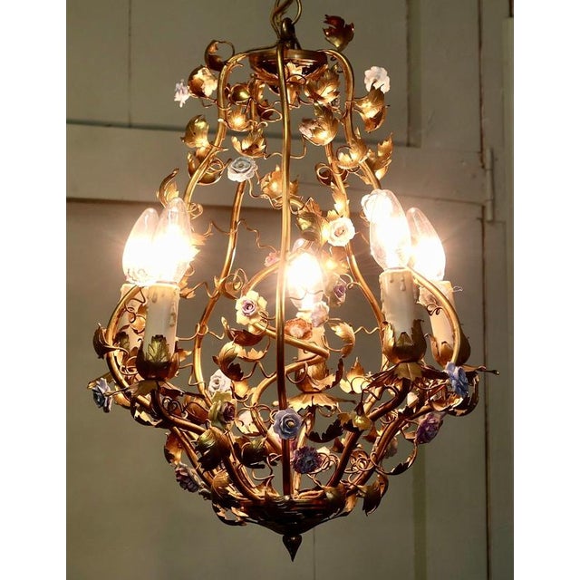 French Toleware Gilt and Ceramic Flower 5 Bulb Chandelier This French Hand made Gilt and Ceramic Chandelier is lit by 5...