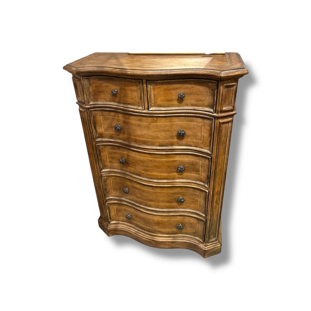 A handsome Hooker Furniture Gentleman’s Chest featuring a warm, richly grained wood finish and beautifully crafted...