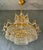 A true eye-catcher. This richly crafted antique chandelier exudes pure luxury and elegance. The gold-colored frame is...