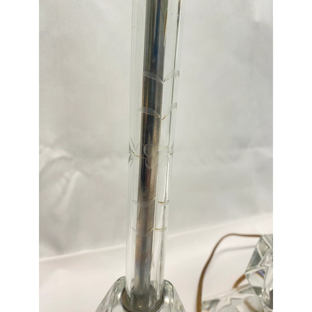 Elegant 1920s Art Deco etched glass lamps featuring beautifully cut geometric bases and slender stems. This matching pair...