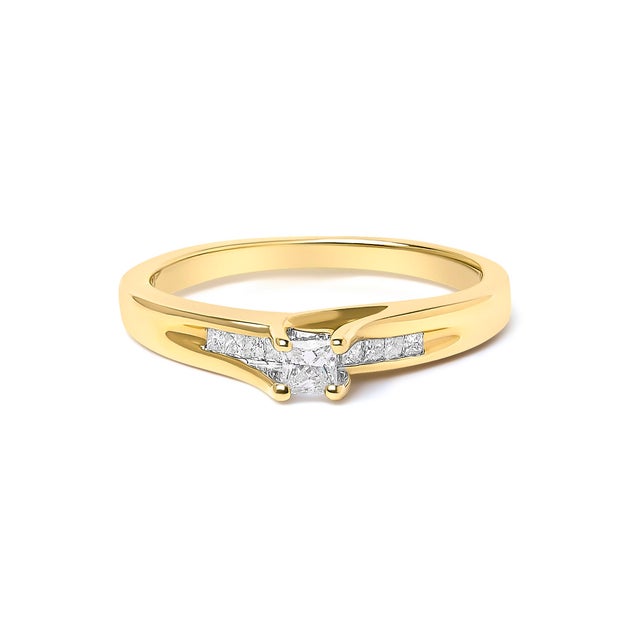 Immerse yourself in the resplendent beauty of this engagement ring, masterfully crafted from radiant 14K yellow gold. Its...