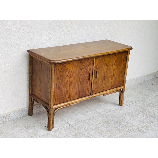 Vintage sideboard in ash and bamboo dating from the 1960s, featuring two storage doors with shelves. Dimensions: H77 W117 D47