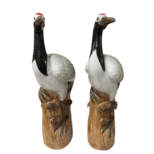 This striking pair of vintage ceramic crane sculptures brings classic Asian art style and elegance to any setting. Modeled...