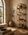 Bring effortless Coastal and Boho charm to your space with this vintage arched-top rattan étagère. Beautifully crafted...