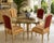 Elegant vintage dinette set featuring a sculptural French Provincial style base with a large round glass top and four...