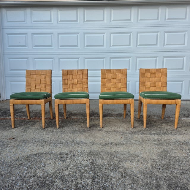 This is a wonderful set of four cane rattan dining chairs stamped Bielecky Brothers. The dining chairs feature solid wood...