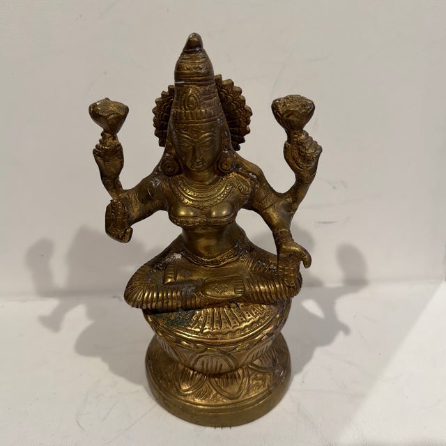 This is a brass statue of Goddess Lakshmi, the Hindu deity of wealth, prosperity, abundance, and spiritual fortune. She is...