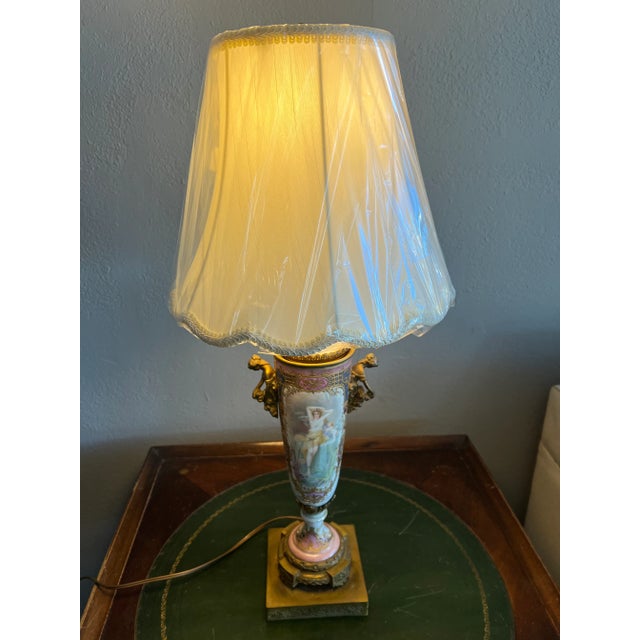 A gorgeous French Sevres Urn turned into table lamp from the 19th Century. Hand painted, woman sitting at a fountain and...