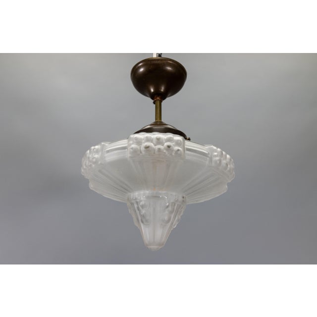 French Art Deco ceiling light with frosted molded glass, circa 1930s. Elegant ceiling light featuring a frosted white...