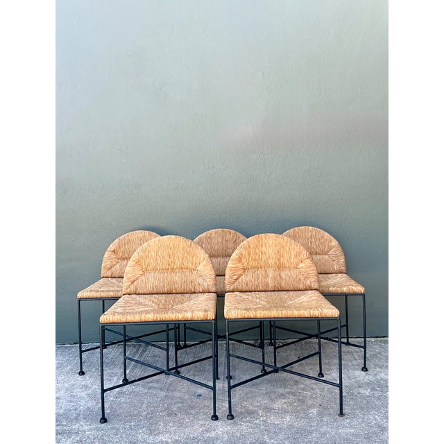 This set of five vintage dining chairs pairs woven rush with black iron frames, a combination that captures the Mid-...
