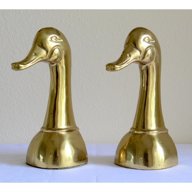 Elevate your library, office, or display shelves with this striking pair of vintage Mid-Century Modern solid brass mallard...