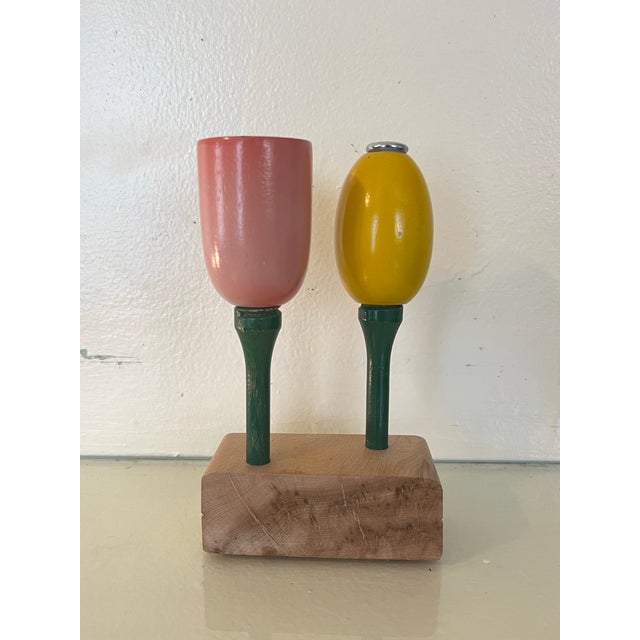 Cheerful Mid Century Modern turned wood salt and pepper shaker set on burl wood stand. the sculptural pair evokes stylized...