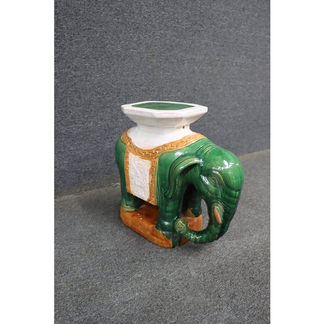 Chinese ceramic elephant-form garden stool or side table, featuring a richly glazed green elephant with molded detailing...