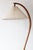 An original, vintage mads caprani floor lamp, crafted in denmark in the 1970s featuring a curved bentwood stem in solid...