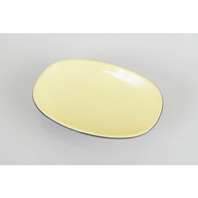 Kjell Blomberg for Upsala Ekeby Dish, model 7008. Oval stoneware dish on raised foot, glossy yellow crackled glaze with...