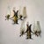 Striking vintage double wall sconce featuring two sculptural, textured clear glass shades set within an elegant...