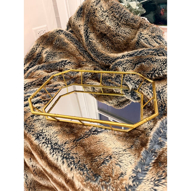 Elegant faux bamboo tray with a mirrored bottom. Gold gilt paint and tiny ball feet. Very nice tray.