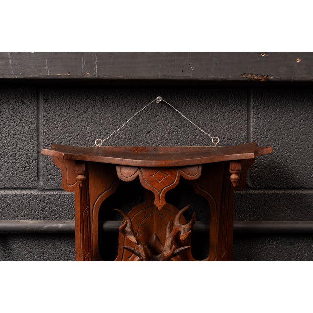 Hand-carved hallway rack or wall shelf with figural three-dimensional deer. The original hanging hardware is attached to...
