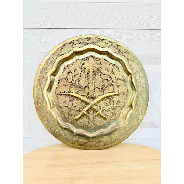 This beautifully intricate mid century brass decorative tray is truly unique. Made in Saudi Arabia with the double sword...
