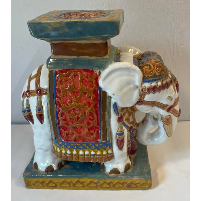 Love the colors in this vintage petite ceramic elephant shaped plant stand. Could also be used for a bookend.