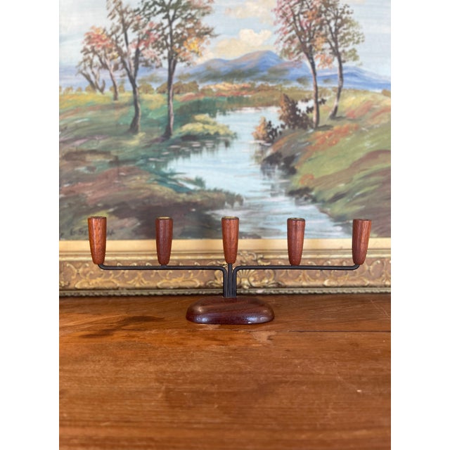 This mid-century modern five-arm candelabra showcases classic Scandinavian design with warm wood, clean lines, and...