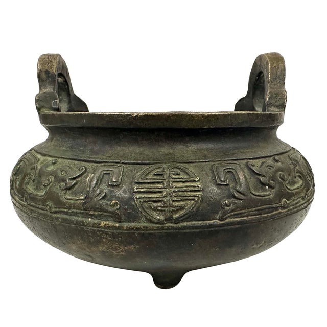 This a Chinese bronze tripod censer (incense burner). The design is heavily inspired by archaic Chinese ritual food...
