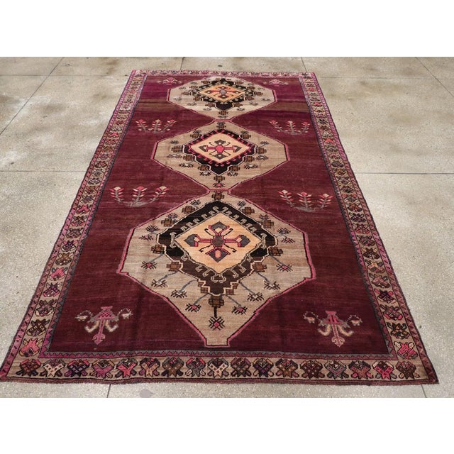 A vintage Turkish Anatolian gallery carpet handmade during the Mid-20th century. Measures: 6' 9" x 11' 4"