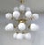 Italian sputnik chandelier with 24 glossy white Murano glass globes mounted on brass frame in unlacquered natural brass...
