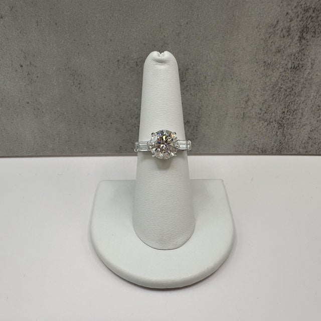 This breathtaking three stone lab grown diamond ring is crafted in 14K white gold and features a 3.01 carat IGI certified...