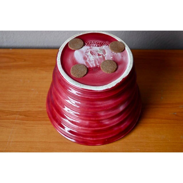 This earthenware cachepot in a deep rose burgundy hue has a lovely spiraled, ringed shape. It's a colorful and charming...