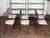 A set of six Italian walnut dining room chairs from the early 19th century, with spindle-shaped backs, carved medallions...