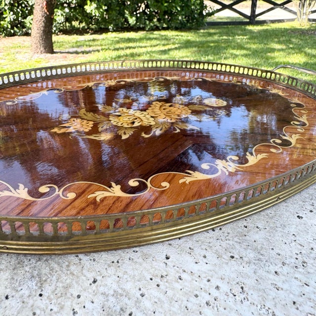 An elegant vintage Italian serving tray featuring finely executed marquetry wood inlay with a classic floral motif at its...