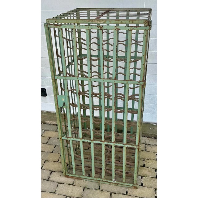 Fabulous steel wine storage rack with working lock and key . Fits 100 wine or champagne bottles. Great color and patina....