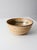 This vintage handmade studio pottery serving bowl features a wheel-thrown form with softly ribbed sides and layered cream,...
