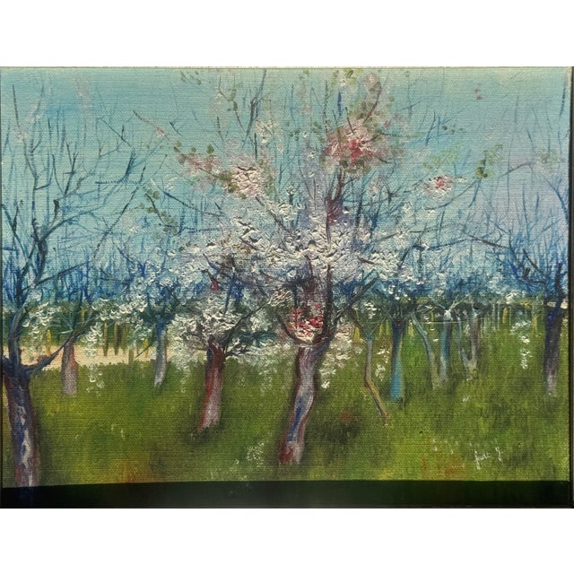 A charming early 20th century European landscape depicting a flowering orchard in spring, painted with expressive, heavily...