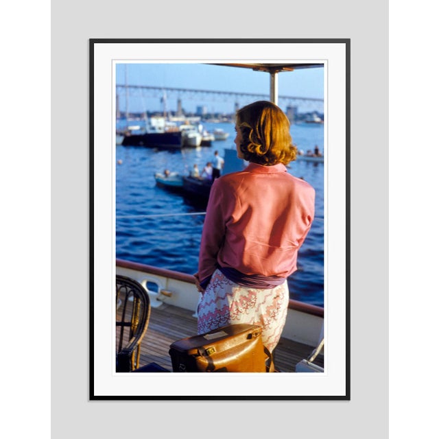 Riverside Gaze by Toni Frissell A woman gazes at passing boats from the deck of a Yacht, circa 1960. (Toni Frissell)...