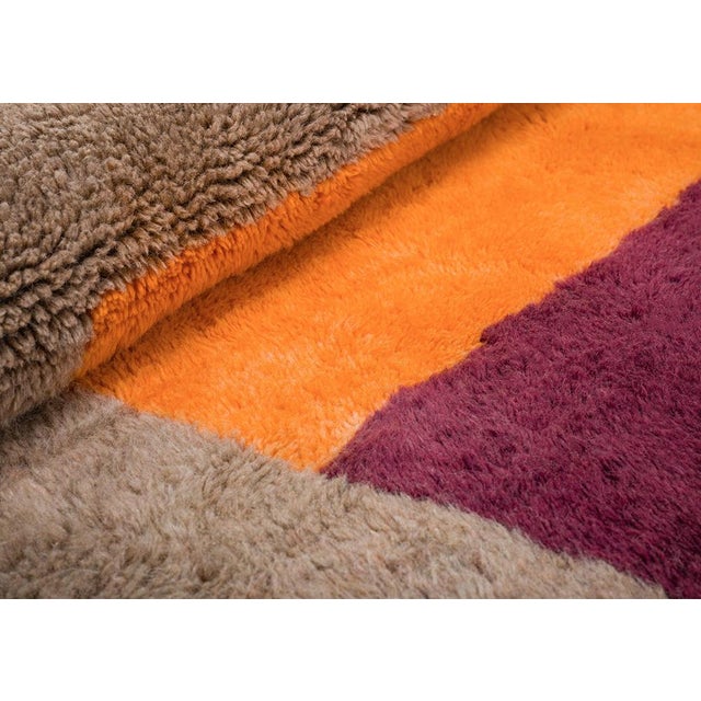 Bold orange and deep plum blocks stack in a confident architectural rhythm against a soft taupe field — modern, graphic,...