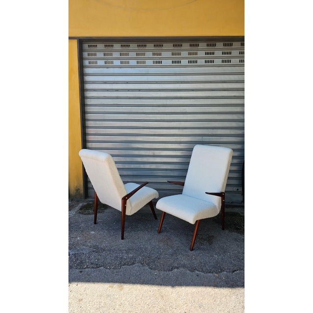 A stunning pair of mid-century modern armchairs, characterized by an elegant design, organic lines, and exceptional...