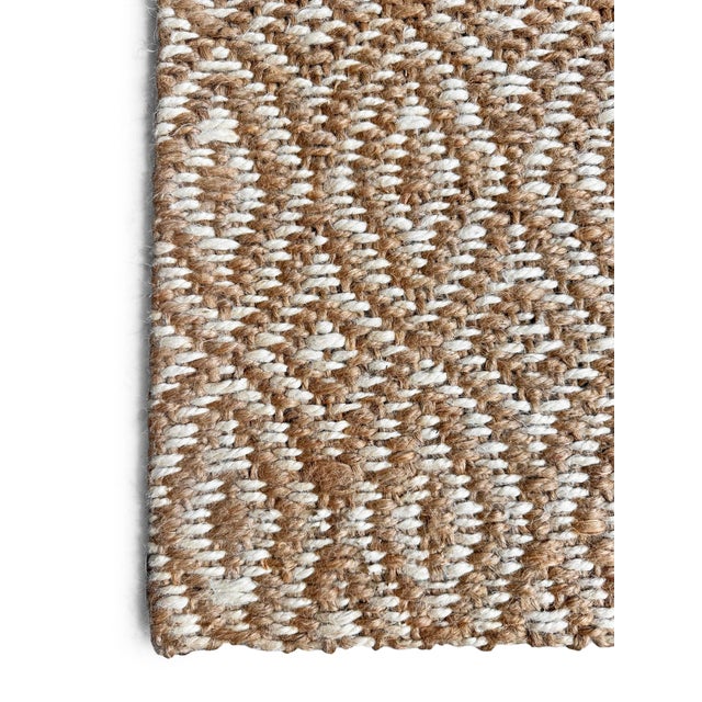 Add organic texture and subtle pattern to your entryway with this woven jute rug, featuring a natural fiber construction...