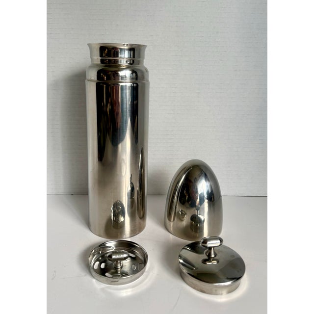 This vintage Metrokane stainless steel cocktail shaker was produced in the mid-20th century. It features a sleek bullet-...
